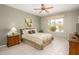 Comfortable bedroom featuring a queen bed, wooden furniture, and neutral decor at 19824 N Valencia Ct, Surprise, AZ 85374