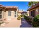 Exterior view featuring a private walkway with desert landscaping and a tiled roof at 19824 N Valencia Ct, Surprise, AZ 85374