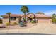 Charming single-story home featuring a tile roof, desert landscaping, and a welcoming front entrance at 19824 N Valencia Ct, Surprise, AZ 85374