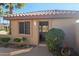 Inviting front entrance with desert landscaping, light fixtures, and a secure screen door at 19824 N Valencia Ct, Surprise, AZ 85374