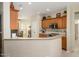 Spacious kitchen featuring wood cabinets, tile backsplash, and modern appliances at 19824 N Valencia Ct, Surprise, AZ 85374
