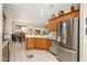 Bright kitchen with stainless steel appliances and wood cabinetry overlooking the breakfast nook at 19824 N Valencia Ct, Surprise, AZ 85374
