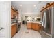 Well-lit kitchen showcasing wooden cabinets, modern appliances, and tiled floors at 19824 N Valencia Ct, Surprise, AZ 85374