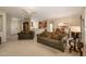 Open-concept living space features comfortable seating, tile flooring, and an adjacent dining area at 19824 N Valencia Ct, Surprise, AZ 85374