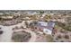 Desert home featuring solar panels, surrounded by native trees and shrubs at 2107 N Campo Allegre Dr, Tempe, AZ 85288