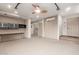 Basement featuring neutral carpet, custom cabinets, and walk-out entrance at 2107 N Campo Allegre Dr, Tempe, AZ 85288