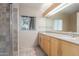 Bathroom featuring double sinks with modern fixtures, large mirror, and tile flooring at 2107 N Campo Allegre Dr, Tempe, AZ 85288