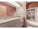 Modern bathroom with double sink vanity, wood panels, and separate tub at 2107 N Campo Allegre Dr, Tempe, AZ 85288