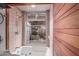 This bathroom features a shower over tub, wood panel and natural light at 2107 N Campo Allegre Dr, Tempe, AZ 85288