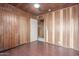 Cozy bedroom with hardwood floors, wood paneling, and closet for storage at 2107 N Campo Allegre Dr, Tempe, AZ 85288
