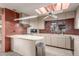 Charming kitchen with skylight, ample cabinet space, and tile backsplash at 2107 N Campo Allegre Dr, Tempe, AZ 85288