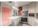 Bright kitchen features updated appliances, stone tile flooring, and ample counter space at 2107 N Campo Allegre Dr, Tempe, AZ 85288