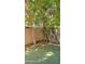 A peaceful back yard, features lovely green turf and mature landscaping that provides shade at 2241 E Pinchot Ave # B3, Phoenix, AZ 85016