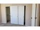 A bedroom closet is highlighted by sliding doors, neutral walls, and carpet at 2241 E Pinchot Ave # B3, Phoenix, AZ 85016