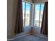 Bedroom featuring a corner window with beige curtains and neutral walls at 2241 E Pinchot Ave # B3, Phoenix, AZ 85016