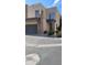 Contemporary townhome exterior with a gray garage door, complemented by stone accents and maintained landscaping at 2241 E Pinchot Ave # B3, Phoenix, AZ 85016