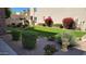 Well-maintained front yard with lush landscaping, including shrubs, vibrant flowers, and a charming yellow fire hydrant at 2241 E Pinchot Ave # B3, Phoenix, AZ 85016