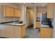 Efficient kitchen design with wood cabinets, dark countertops, and stainless steel appliances, offering functionality at 2241 E Pinchot Ave # B3, Phoenix, AZ 85016