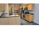 Well-lit kitchen showcases wood cabinetry, dark countertops, and stainless steel appliances at 2241 E Pinchot Ave # B3, Phoenix, AZ 85016