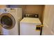 Laundry room features a modern front load washer and a top load dryer at 2241 E Pinchot Ave # B3, Phoenix, AZ 85016