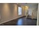 Comfortable living room with a staircase, complemented by neutral walls and dark tile flooring at 2241 E Pinchot Ave # B3, Phoenix, AZ 85016