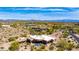 Stunning aerial view of luxury home with private pool, desert landscaping and mountain views on a sunny day at 24548 N 121St Pl, Scottsdale, AZ 85255