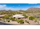 Luxury home with desert landscaping, red brick driveway, stone accents, and a mountain backdrop at 24548 N 121St Pl, Scottsdale, AZ 85255