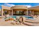 Backyard features pool, spa, desert landscaping, and stucco exterior of custom home at 24548 N 121St Pl, Scottsdale, AZ 85255