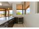 Contemporary bar features a wine fridge and outdoor desert landscape at 24548 N 121St Pl, Scottsdale, AZ 85255