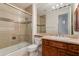 Bathroom boasts a vanity with tan countertop and glass-enclosed shower showcasing tiled walls at 24548 N 121St Pl, Scottsdale, AZ 85255