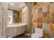 Unique bathroom with stone tile, marble countertop sink, and modern fixtures at 24548 N 121St Pl, Scottsdale, AZ 85255