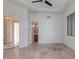 Bedroom featuring tile flooring, modern ceiling fan, and ensuite bathroom at 24548 N 121St Pl, Scottsdale, AZ 85255