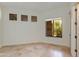 Bedroom with neutral-toned walls and tile floors, complemented by natural light from the window at 24548 N 121St Pl, Scottsdale, AZ 85255