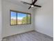 Bright bedroom featuring desert views from a large window and a ceiling fan at 24548 N 121St Pl, Scottsdale, AZ 85255