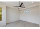 Minimalist bedroom design featuring wood floors, a ceiling fan, and natural light at 24548 N 121St Pl, Scottsdale, AZ 85255