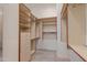 Walk-in closet with open shelving, drawers and tiled floors at 24548 N 121St Pl, Scottsdale, AZ 85255