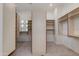 Walk-in closet with open shelving and tiled floors at 24548 N 121St Pl, Scottsdale, AZ 85255