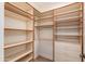 Spacious walk-in closet featuring custom shelving and drawers for optimized storage at 24548 N 121St Pl, Scottsdale, AZ 85255