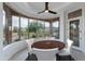 Bright breakfast nook with a round table, chairs, large windows, and views of the desert landscape at 24548 N 121St Pl, Scottsdale, AZ 85255