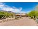 Exterior front elevation displays long driveway, three-car garage, and desert landscaping at 24548 N 121St Pl, Scottsdale, AZ 85255