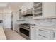 Modern kitchen featuring stainless appliances, marble countertops, and white cabinetry at 24548 N 121St Pl, Scottsdale, AZ 85255