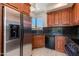 Close-up of kitchen with stainless steel appliances, wood cabinets, and granite countertops at 24548 N 121St Pl, Scottsdale, AZ 85255