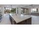 Open kitchen boasts large island, stainless faucet, scenic desert views from expansive windows at 24548 N 121St Pl, Scottsdale, AZ 85255