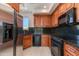 Close-up of kitchen featuring wood cabinets, granite countertops, and stainless steel appliances at 24548 N 121St Pl, Scottsdale, AZ 85255