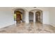 Open floor plan with tile flooring displays arched doorways, front door, and hallways at 24548 N 121St Pl, Scottsdale, AZ 85255