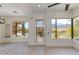 Bright living room with scenic views, wood flooring, and a glass paneled entrance at 24548 N 121St Pl, Scottsdale, AZ 85255