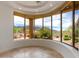 Bright living room featuring bay windows with views of desert landscaping at 24548 N 121St Pl, Scottsdale, AZ 85255