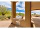 Covered outdoor kitchen features built-in grill, counter space and desert views beyond the patio at 24548 N 121St Pl, Scottsdale, AZ 85255