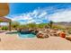 Beautiful pool and spa surrounded by desert landscaping, rock features, and lounge chairs under a bright sky at 24548 N 121St Pl, Scottsdale, AZ 85255