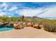 Scenic backyard features a sparkling pool, lounge chairs, desert landscaping, and mountain views at 24548 N 121St Pl, Scottsdale, AZ 85255